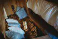 Creative sleeping nook with pillows and netting in a rustic Fairbanks Alaska treehouse rental or adventure lodge