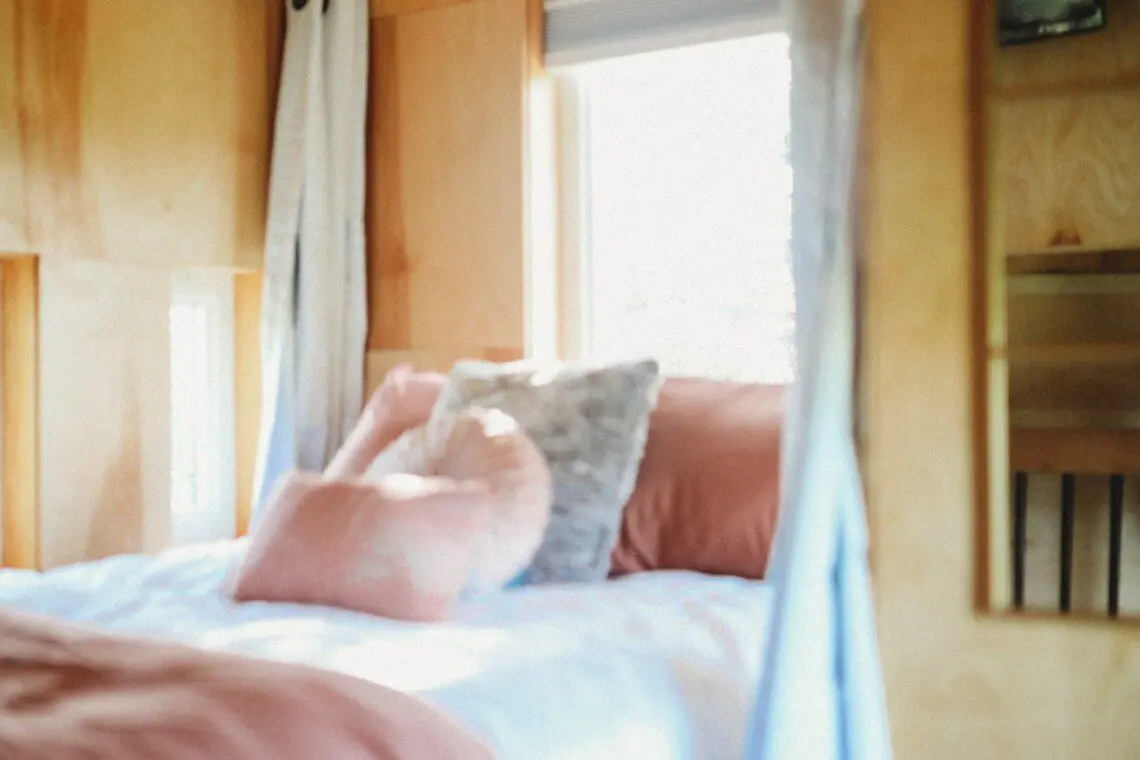 Warm and inviting treehouse bedroom with soft pillows and natural light in Fairbanks, Alaska