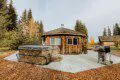 Log cabin with hot tub and grill in a wooded Fairbanks Alaska setting