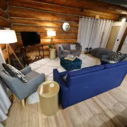 Rustic log cabin living room with modern furniture and soft lighting in Fairbanks Alaska