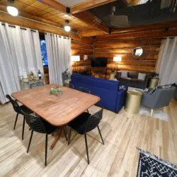 Rustic log cabin living room with modern furniture and soft lighting in Fairbanks Alaska