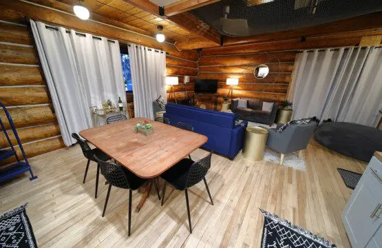 Rustic log cabin living room with modern furniture and soft lighting in Fairbanks Alaska