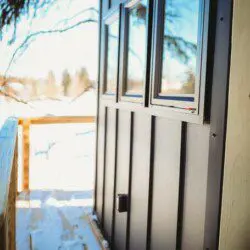 Wooden staircase built among snow-covered trees leading up to a treehouse in Fairbanks, Alaska.