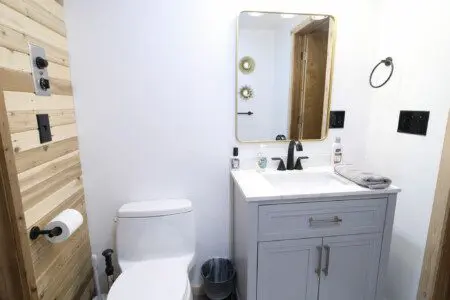 Rustic wood-accented bathroom with white vanity and natural light in Fairbanks Alaska