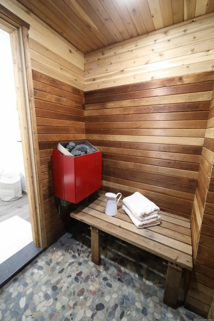 Rustic wood-accented bathroom with white vanity and natural light in Fairbanks Alaska