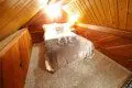 Warm wooden attic-style loft bedroom with double bed and soft lighting in Fairbanks Alaska