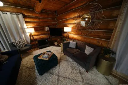 Rustic log cabin living room with modern furniture and soft lighting in Fairbanks Alaska