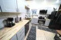 Sleek kitchen with light wood counters, gray cabinets, stainless steel appliances in a Fairbanks Alaska rental