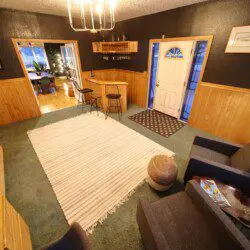 Warm lodge entrance with bar, seating area, and dining room in Fairbanks, Alaska.