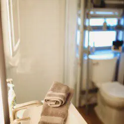Modern bathroom with mirror and sink inside restored railcar lodge in Fairbanks.