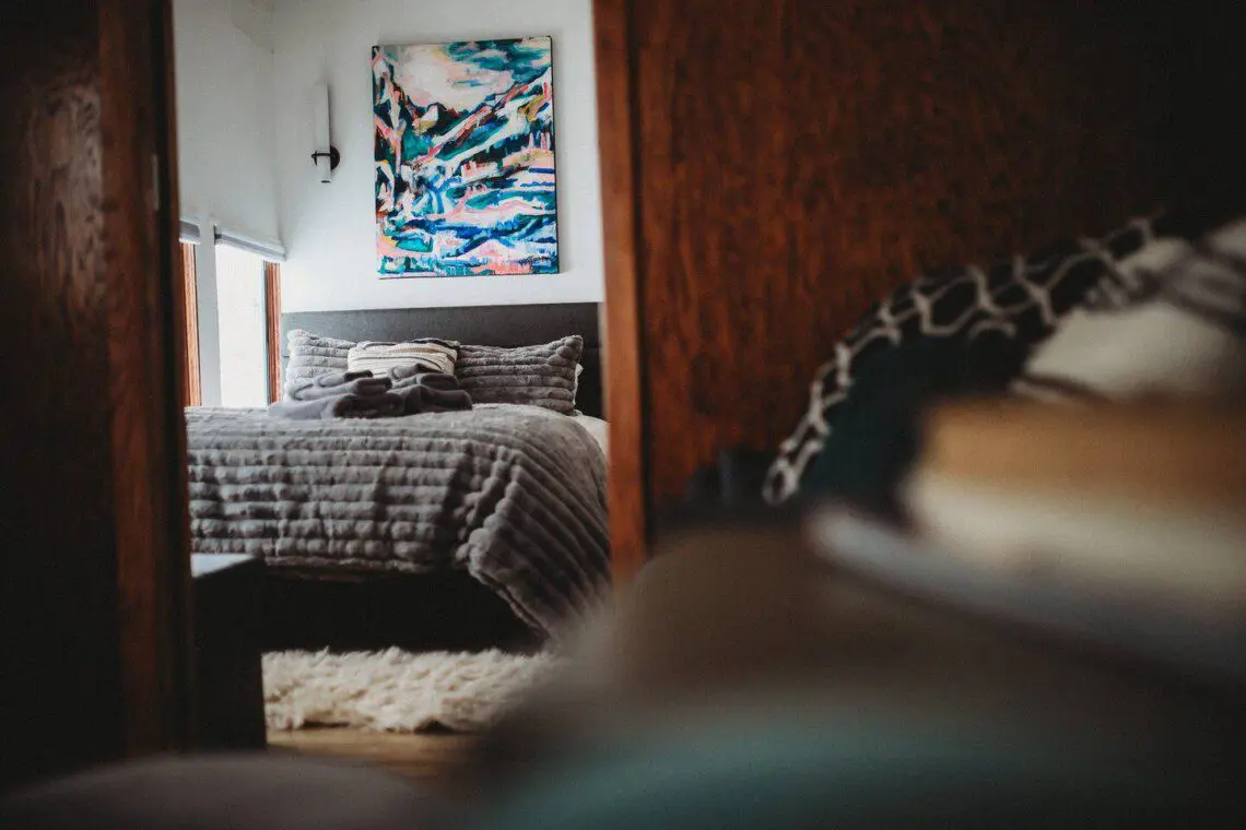Bedroom and seating area inside restored Alaska railroad lodge in Fairbanks.
