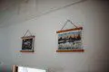 Framed historic Fairbanks prints on white wall in vintage railcar lodge.