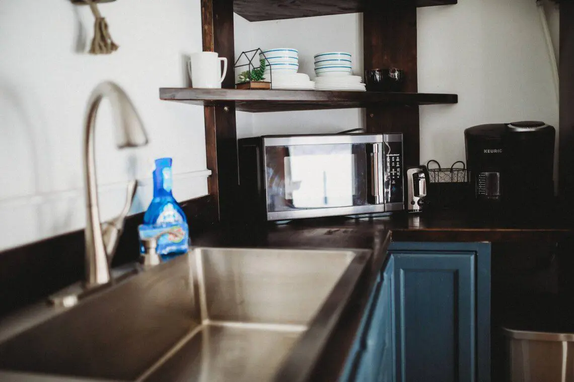 Modern kitchen inside restored railcar at Alaska adventure lodge in Fairbanks.