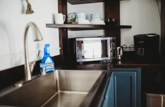 Modern kitchen inside restored railcar at Alaska adventure lodge in Fairbanks.