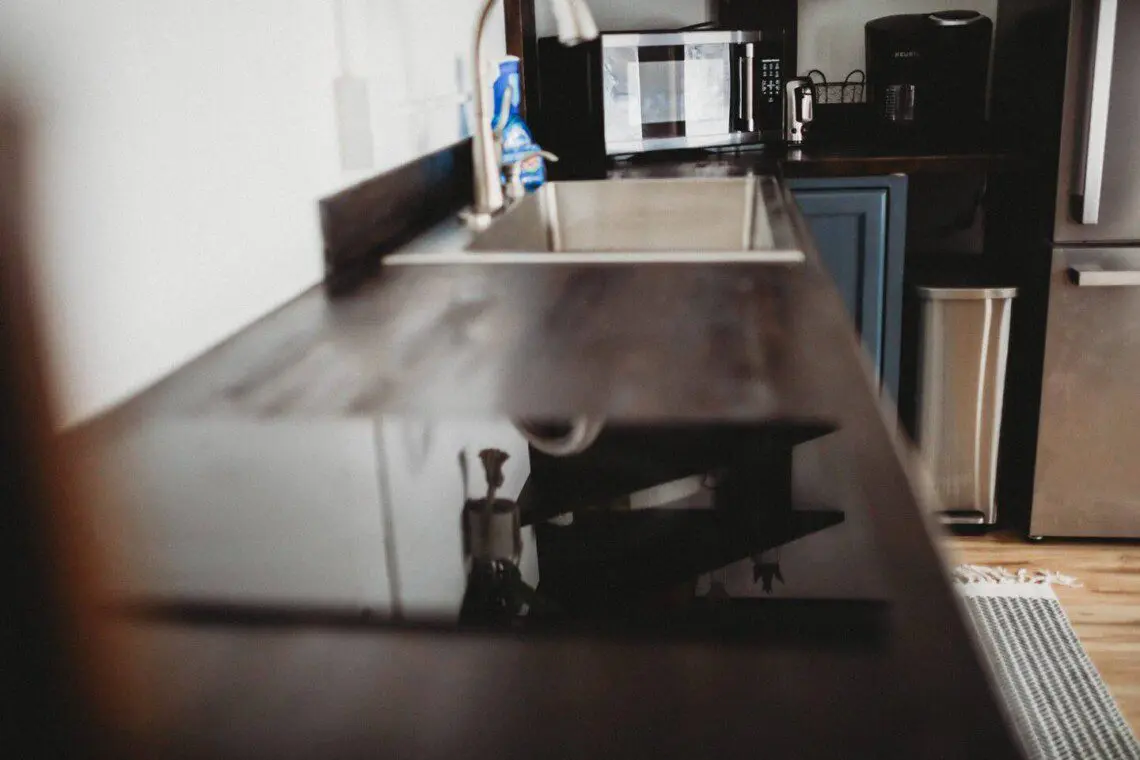 Modern kitchen inside restored railcar at Alaska adventure lodge in Fairbanks.
