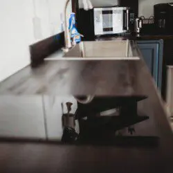 Modern kitchen inside restored railcar at Alaska adventure lodge in Fairbanks.