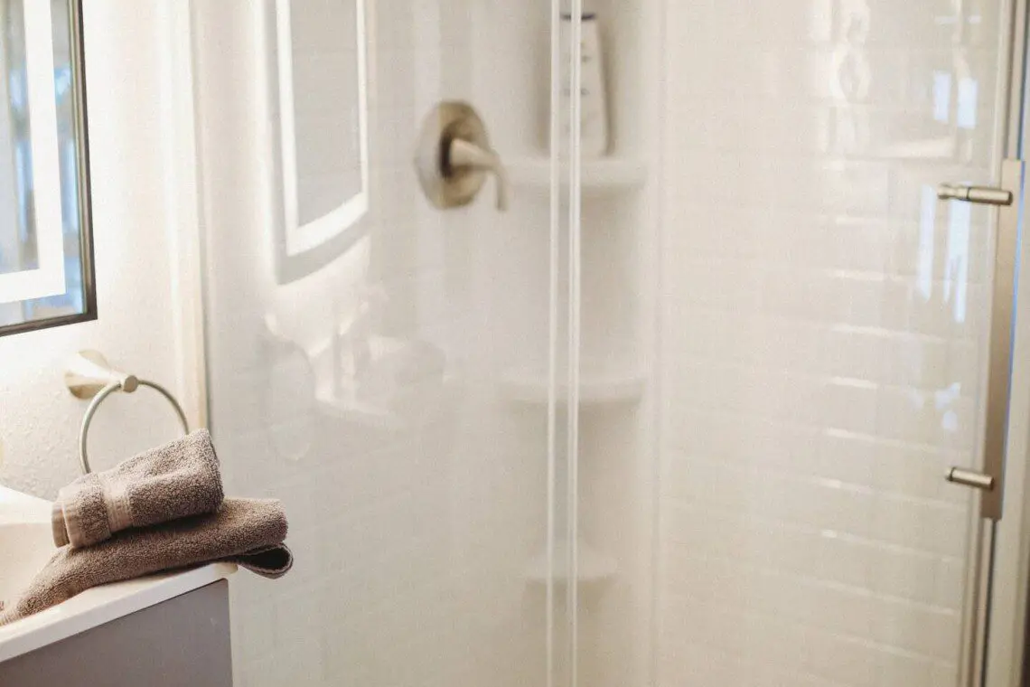 Modern bathroom with mirror and sink inside restored railcar lodge in Fairbanks.