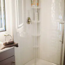 Modern bathroom with mirror and sink inside restored railcar lodge in Fairbanks.