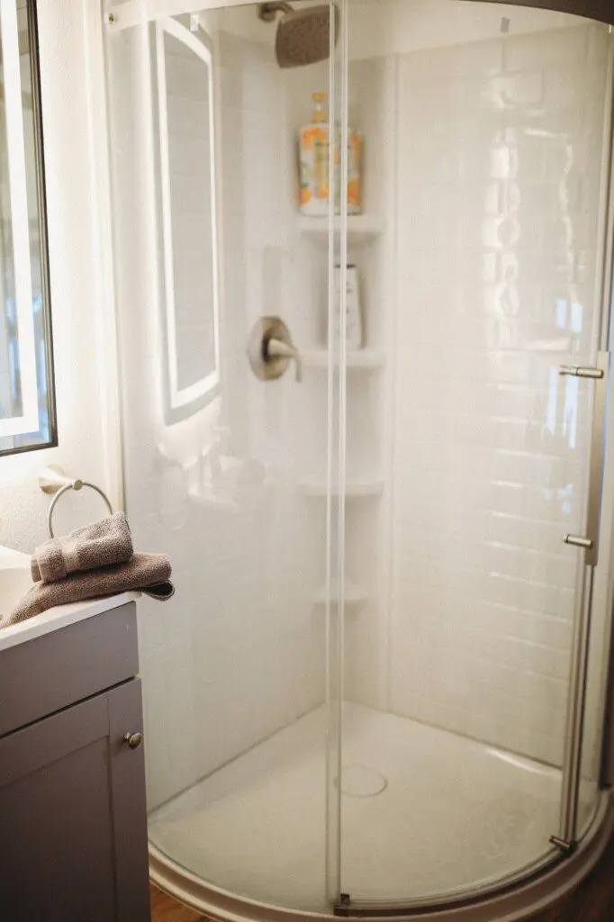 Modern bathroom with mirror and sink inside restored railcar lodge in Fairbanks.