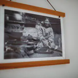 Framed historic Fairbanks prints on white wall in vintage railcar lodge.