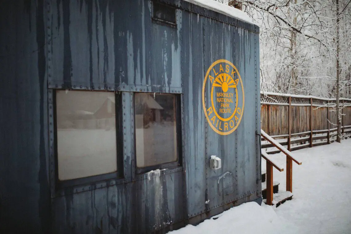 Snow-covered Alaska Railroad car lodge stay in Fairbanks adventure setting.