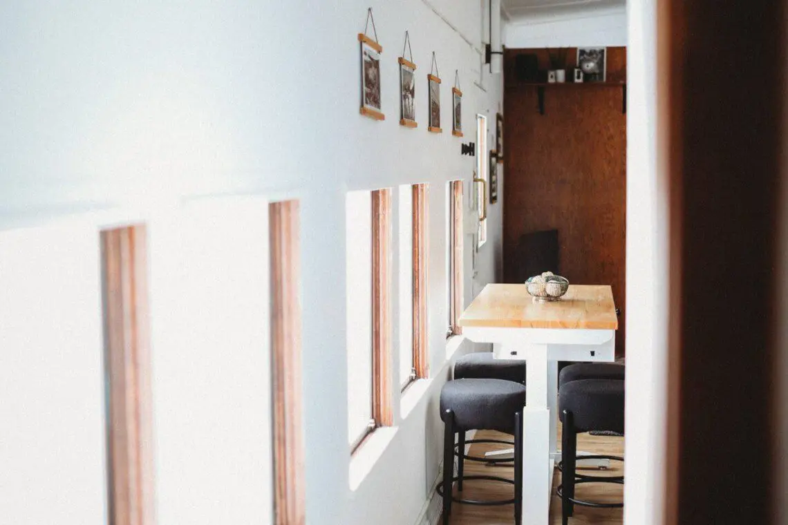 Dining area with windows inside restored railcar lodge in Fairbanks, Alaska.
