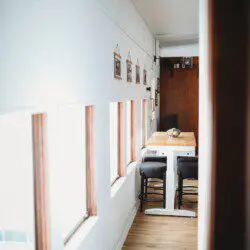 Dining area with windows inside restored railcar lodge in Fairbanks, Alaska.