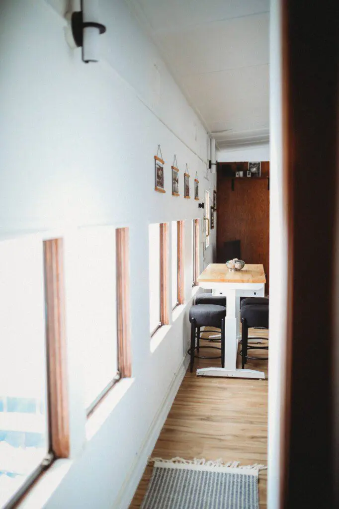Dining area with windows inside restored railcar lodge in Fairbanks, Alaska.