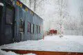 Historic railcar lodging with snowy deck and winter trees in Fairbanks Alaska