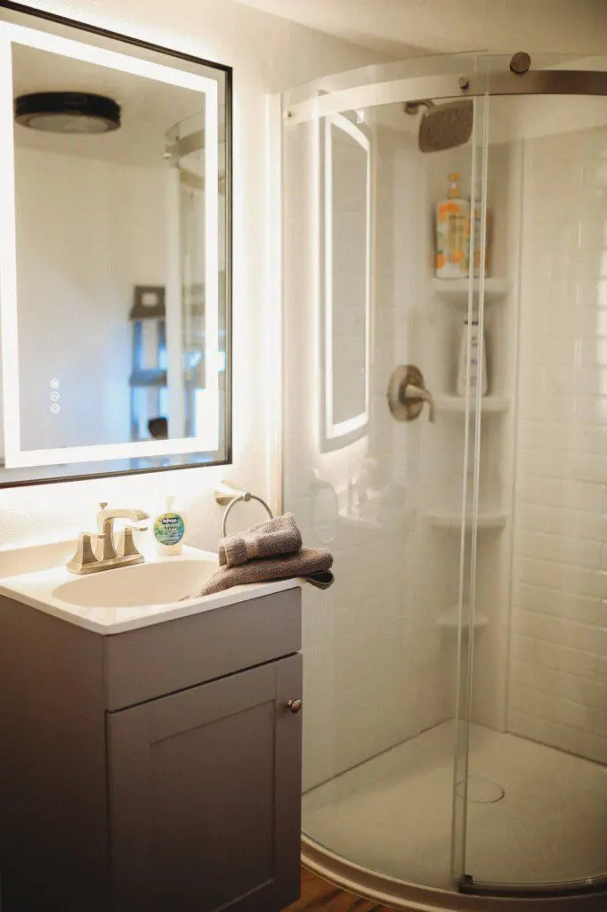 Modern bathroom with mirror and sink inside restored railcar lodge in Fairbanks.
