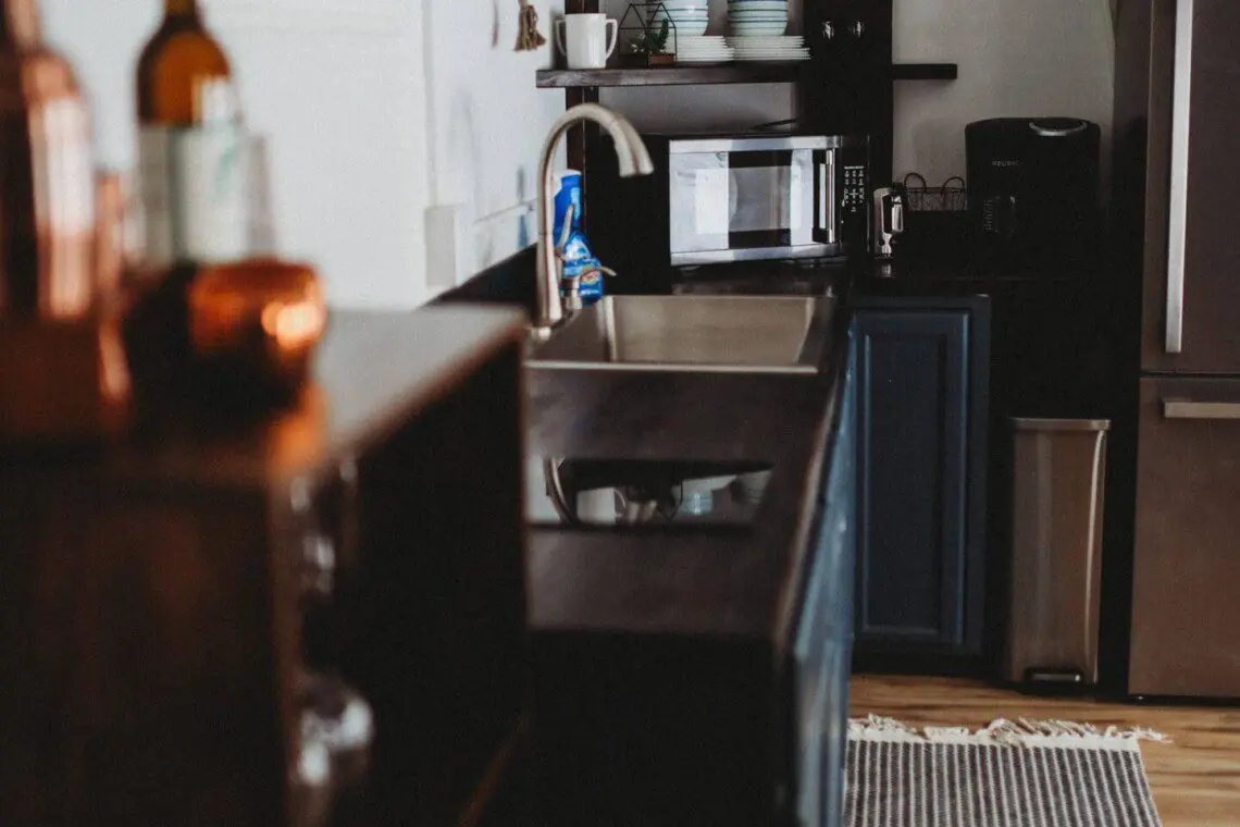 Modern kitchen inside restored railcar at Alaska adventure lodge in Fairbanks.