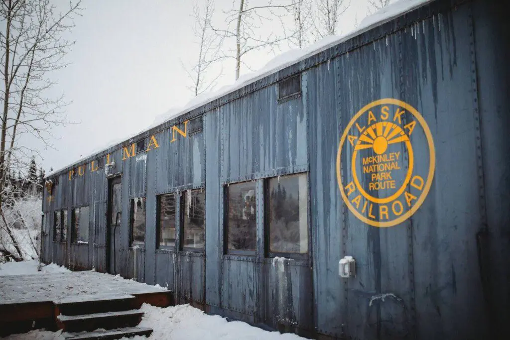 Snow-covered Alaska Railroad car lodge stay in Fairbanks adventure setting.