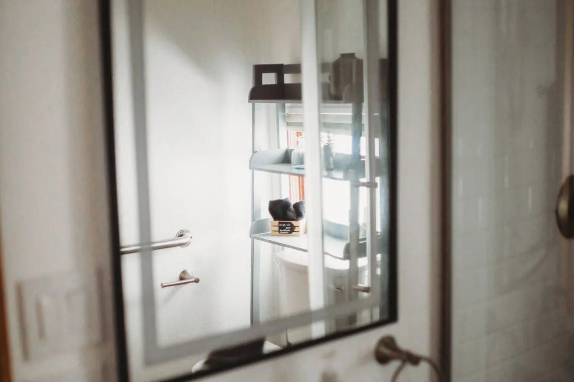 Modern bathroom with mirror and sink inside restored railcar lodge in Fairbanks.