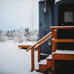 Snowy forest view beside Alaska Railroad lodge stay in Fairbanks, Alaska.