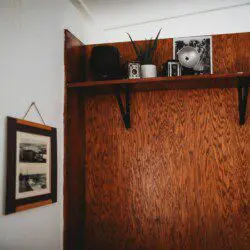 Shelf with vintage cameras and framed prints in Alaska railcar lodge in Fairbanks.