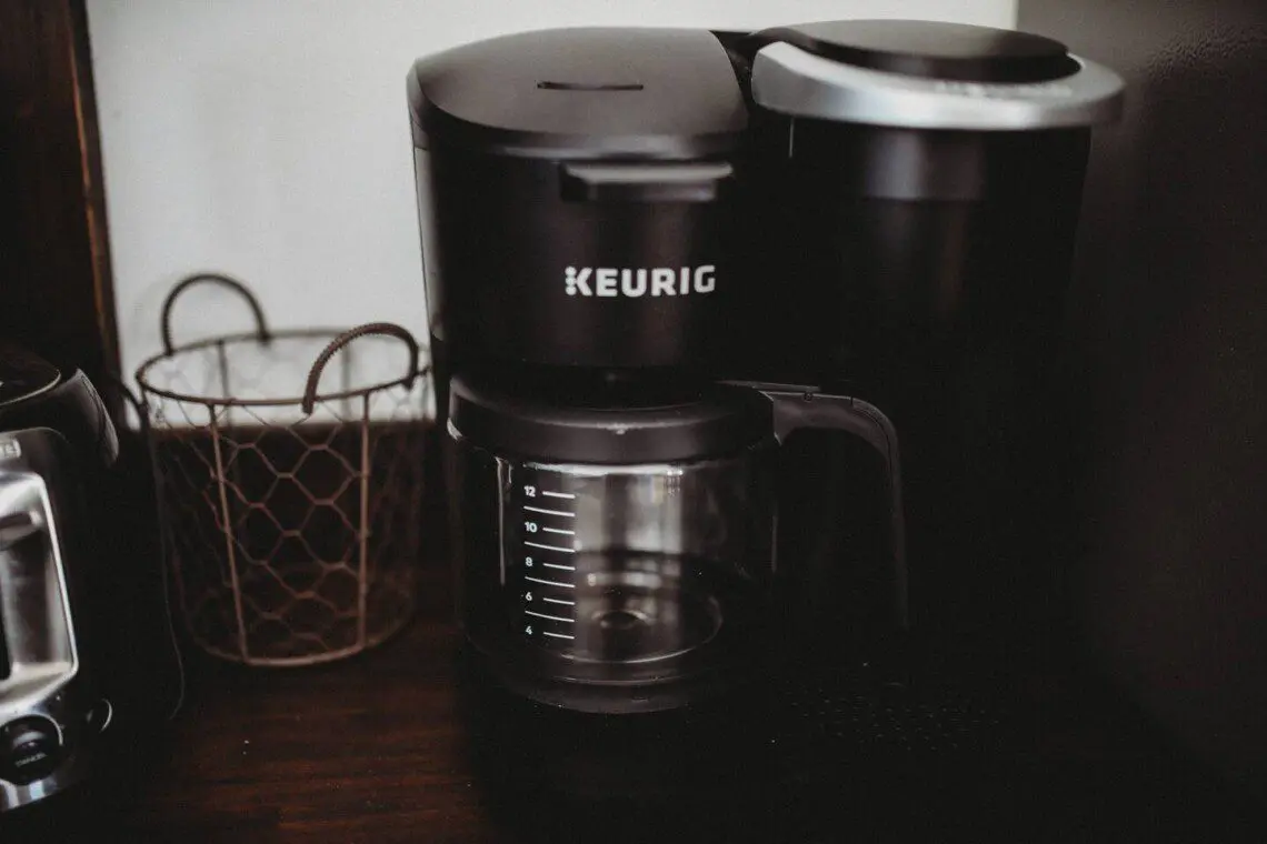Keurig coffee maker with glass carafe on a wooden counter in a Fairbanks Alaska lodge rental
