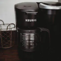 Keurig coffee maker with glass carafe on a wooden counter in a Fairbanks Alaska lodge rental