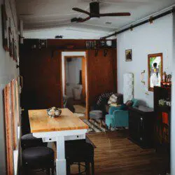 Modern open-plan interior with dining table, ceiling fan, and cozy seating in a Fairbanks Alaska lodge  Caption: