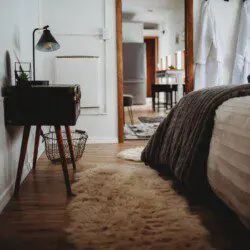Comfortable bed with folded towels inside Alaska railroad car lodge in Fairbanks.