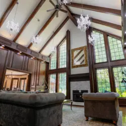 Spacious lodge interior with high ceilings, chandeliers, and large windows in a Fairbanks adventure lodge