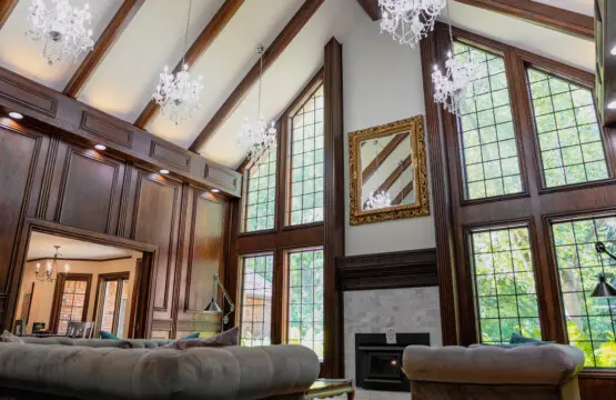 Spacious lodge interior with high ceilings, chandeliers, and large windows in a Fairbanks adventure lodge