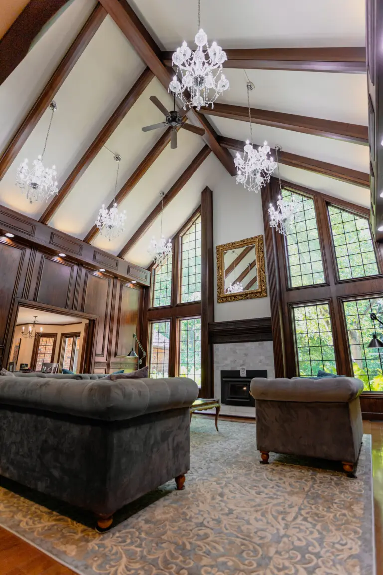 Spacious lodge interior with high ceilings, chandeliers, and large windows in a Fairbanks adventure lodge