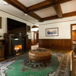 Spacious lodge interior with high ceilings, chandeliers, and large windows in a Fairbanks adventure lodge