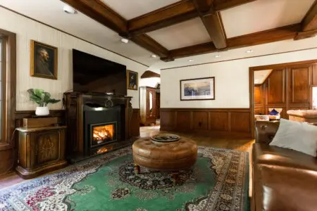 Spacious lodge interior with high ceilings, chandeliers, and large windows in a Fairbanks adventure lodge