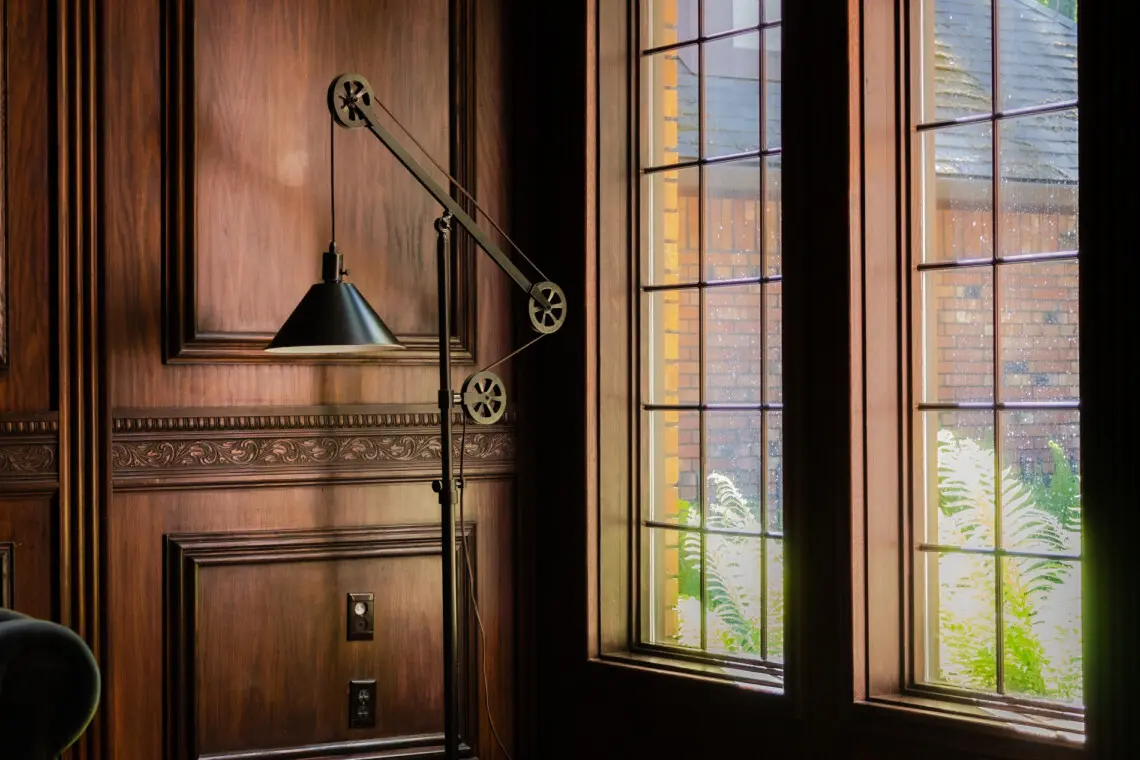 Spacious lodge interior with high ceilings, chandeliers, and large windows in a Fairbanks adventure lodge