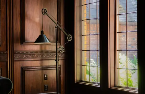 Spacious lodge interior with high ceilings, chandeliers, and large windows in a Fairbanks adventure lodge