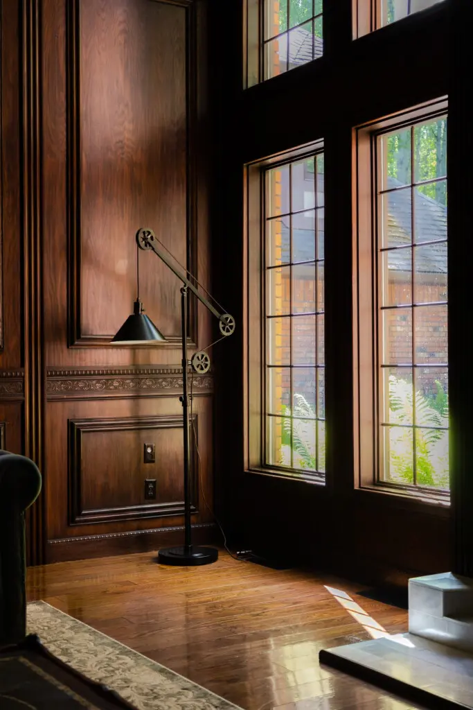 Spacious lodge interior with high ceilings, chandeliers, and large windows in a Fairbanks adventure lodge
