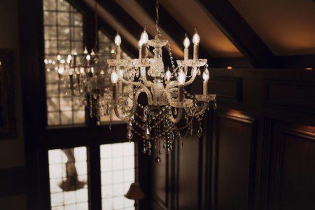 Glowing chandelier hanging from vaulted ceiling in a grand Fairbanks Alaska lodge interior