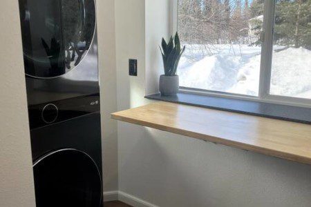 Stacked washer and dryer unit in modern Fairbanks Alaska treehouse rental