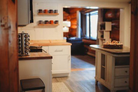 Inviting kitchen space with white cabinets, wooden countertops, and rustic decor in a Fairbanks Alaska lodge